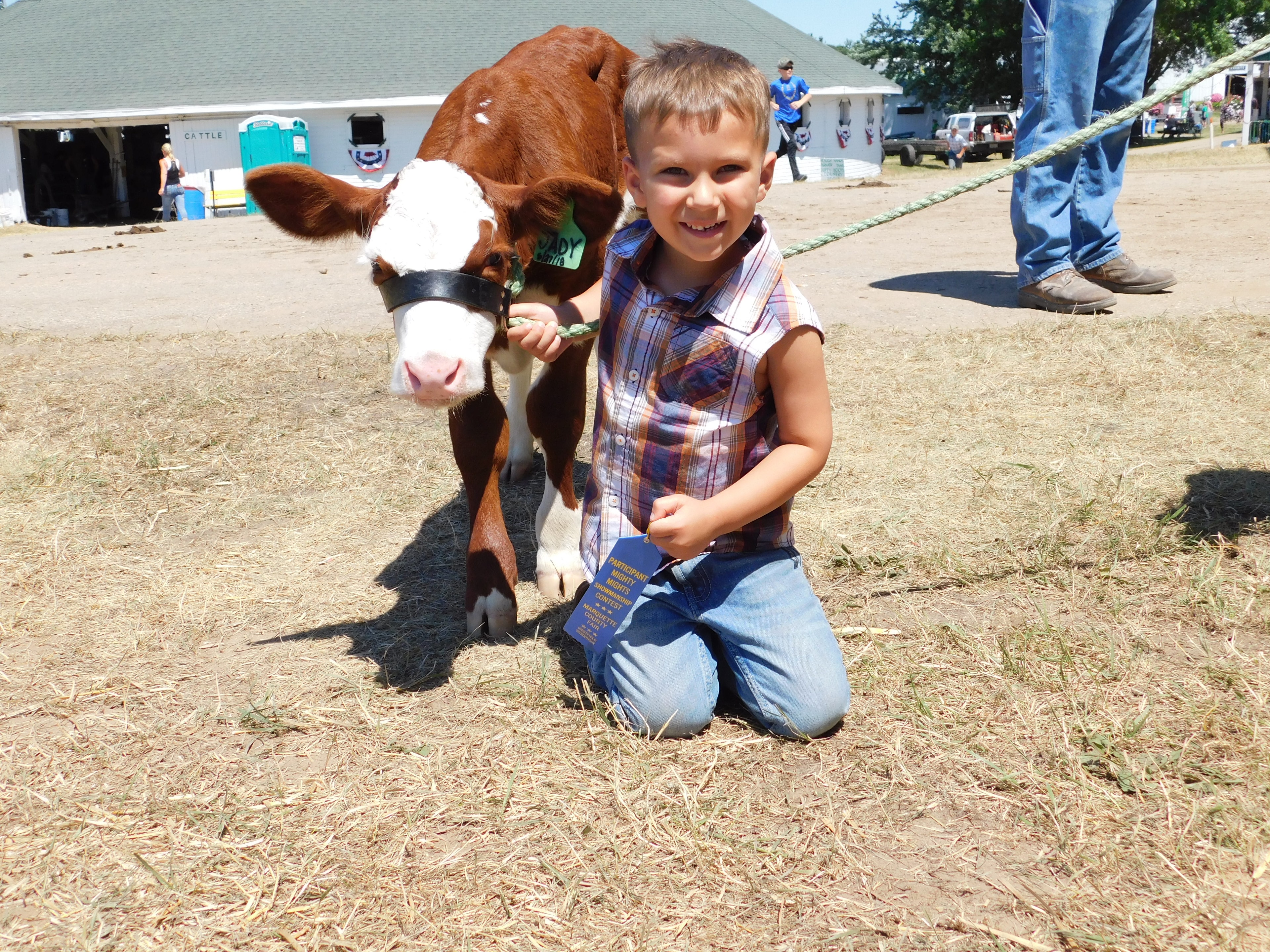 Young boy posing with his show calf at the Marquette County Fair Mighty Mites show